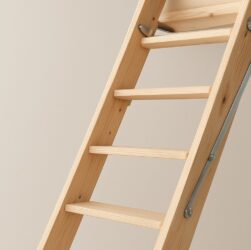 Eco-friendly wooden loft ladder against a plain wall